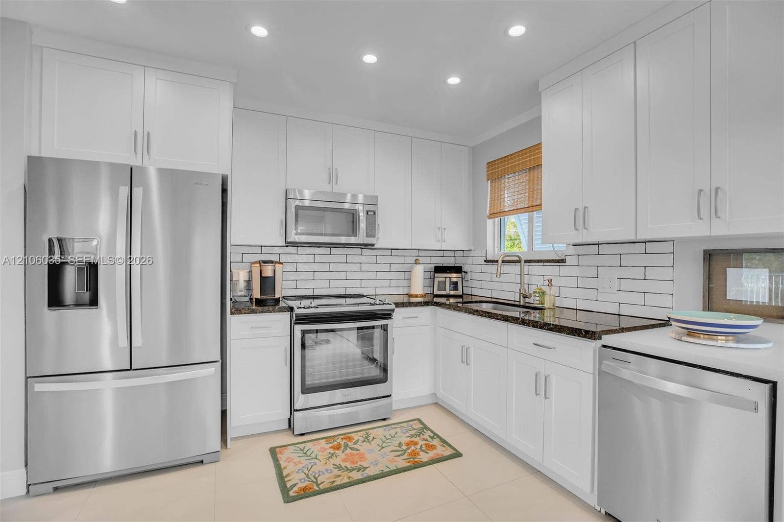 128 Dove Avenue, Tavernier, FL 33070 Kitchen featuring white shaker cabinetry, dark stone countertops, stainless steel appliances, subway tile backsplash, and recessed ceiling lighting