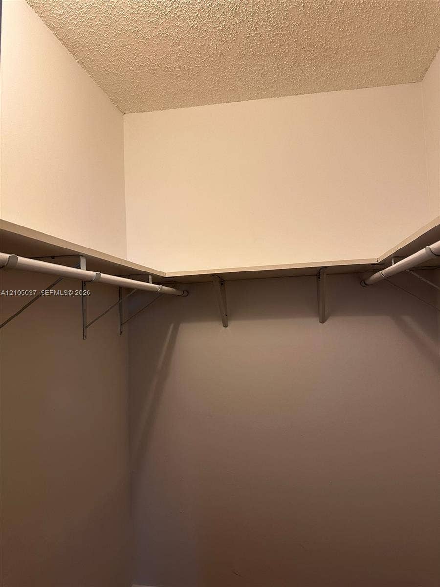 14951 SW 82nd Lane, #17-504, Miami, FL 33193 Storage area featuring wrap-around shelving and mounted clothing rods