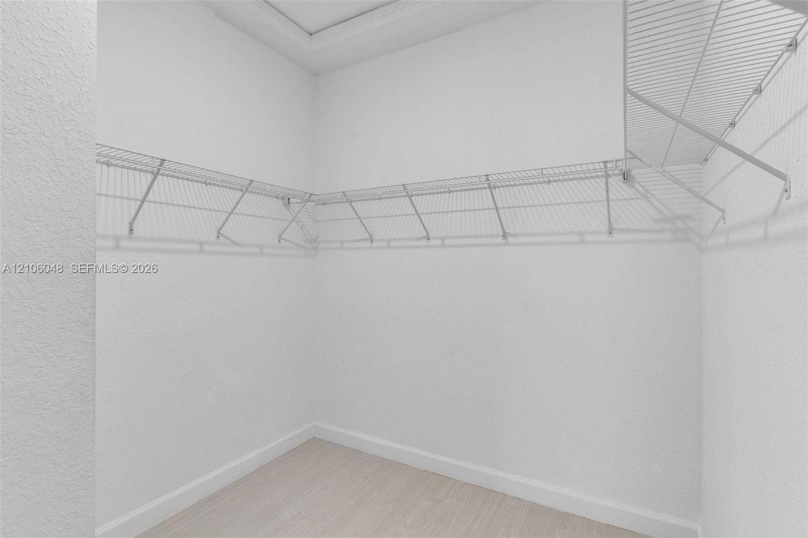 25134 SW 108th Court, Homestead, FL 33032 Walk-in closet featuring light-toned flooring, bright neutral walls, and integrated white wire shelving