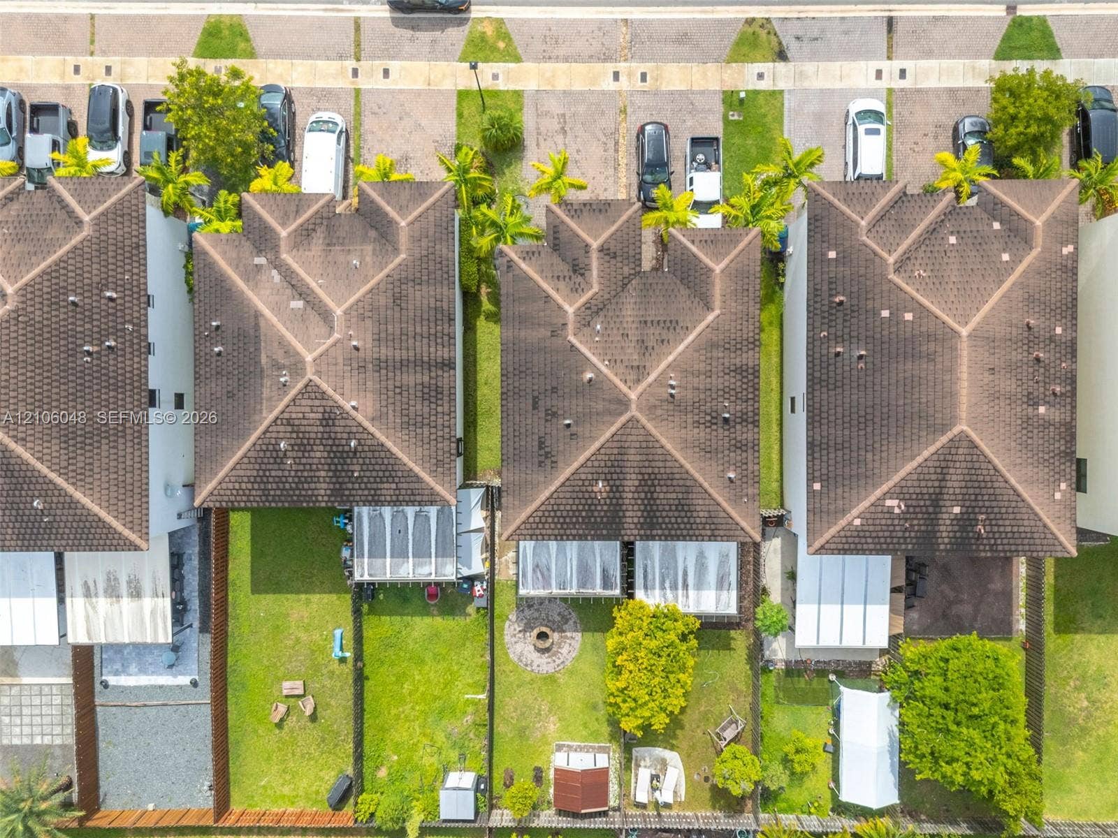 25134 SW 108th Court, Homestead, FL 33032 Aerial perspective of residential lots featuring fenced rear yards, established landscaping, and paved driveway access