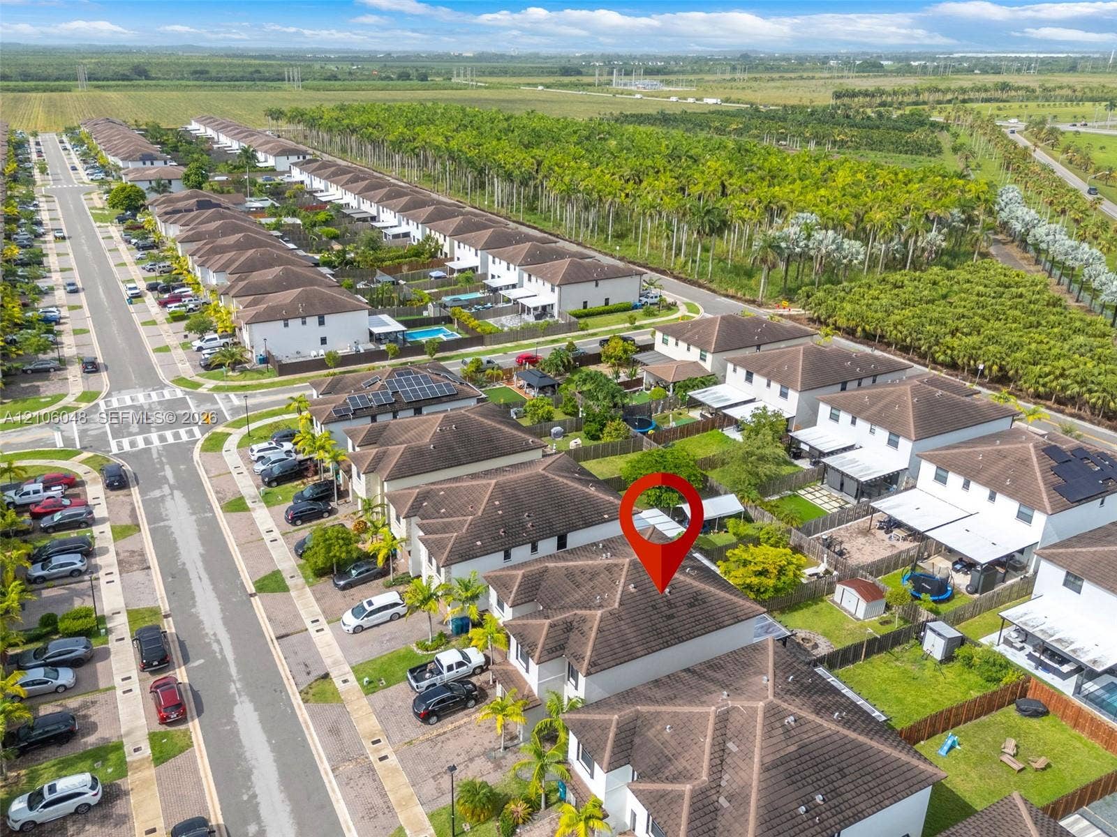 25134 SW 108th Court, Homestead, FL 33032 Aerial perspective of a multi-unit residential community featuring hipped roof structures, paved street access, and fenced yard spaces