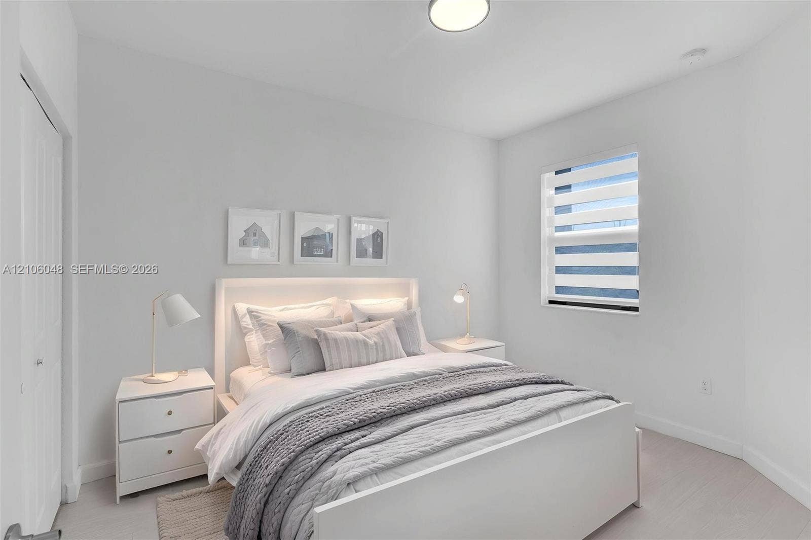 25134 SW 108th Court, Homestead, FL 33032 Neutral-toned room featuring high ceilings, light-colored carpeting, a recessed ceiling light fixture, and a window with horizontal tiered shades