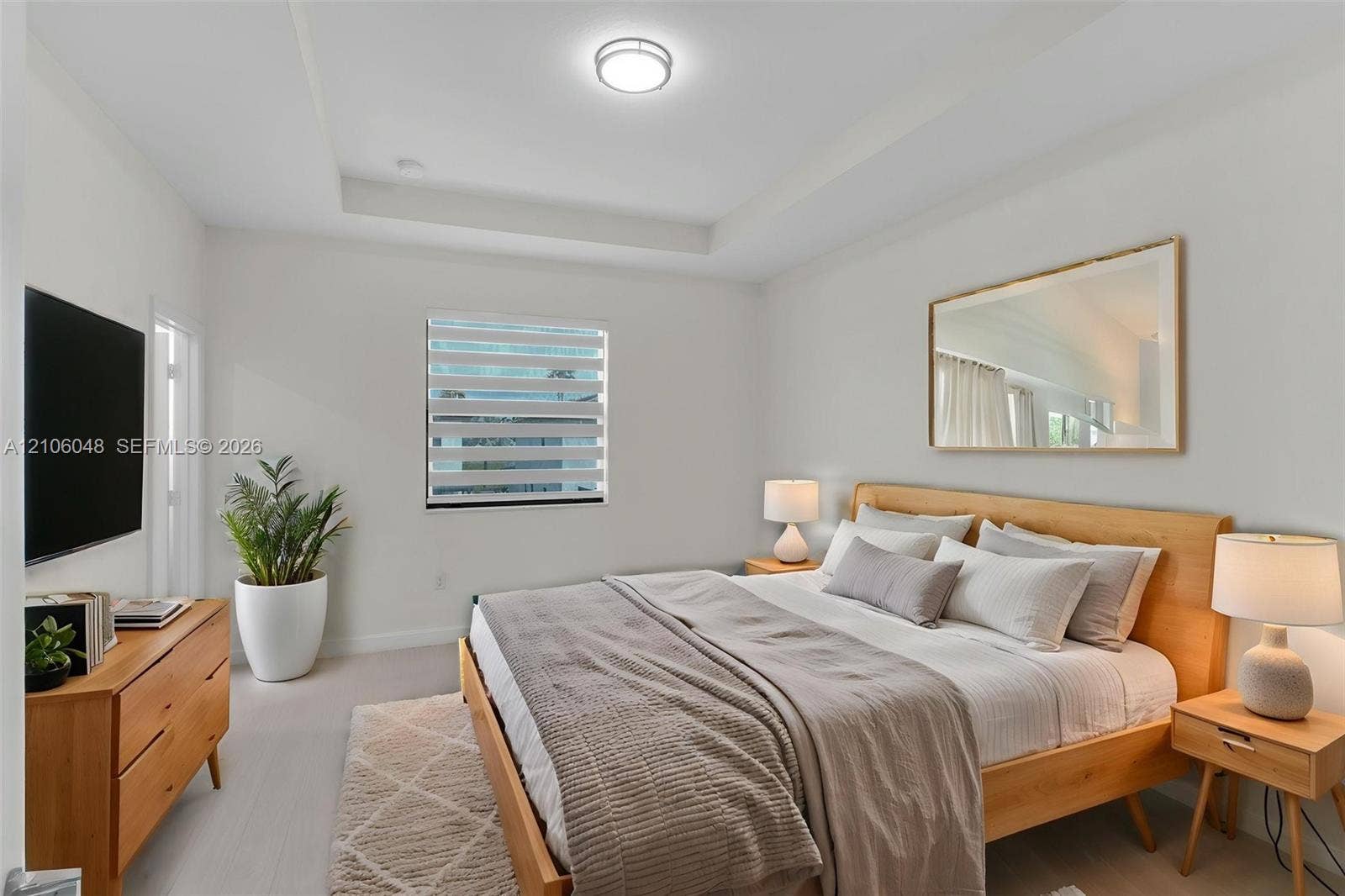 25134 SW 108th Court, Homestead, FL 33032 Tray ceiling, neutral walls, light-toned flooring, and window with adjustable light-filtering shade