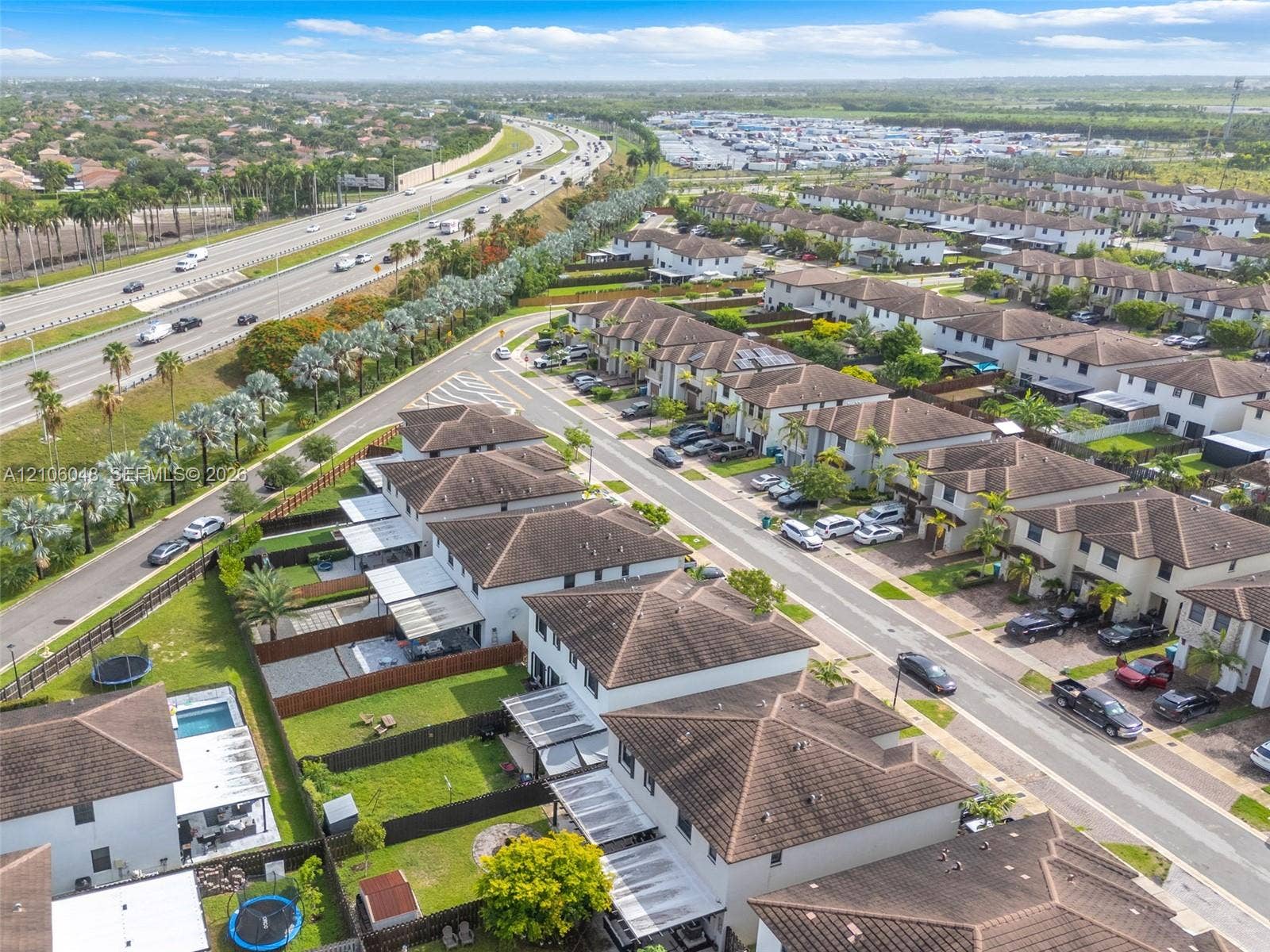 25134 SW 108th Court, Homestead, FL 33032 Aerial perspective of a residential neighborhood featuring multi-story homes with hipped tile roofing and enclosed rear yards