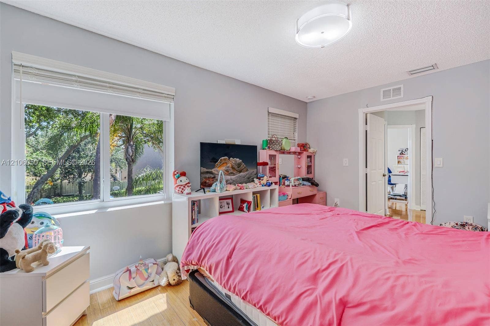 1065 Weeping Willow Way, #0, Hollywood, Hollywood, FL 33019 Bedroom featuring wood-finish flooring, dual-pane windows, and a semi-flush mount light fixture