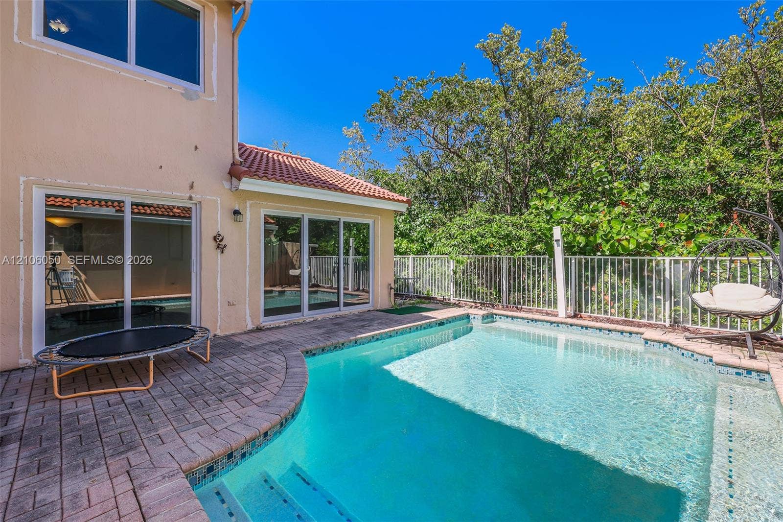 1065 Weeping Willow Way, #0, Hollywood, Hollywood, FL 33019 Backyard featuring an in-ground pool with built-in stairs, paver stone decking, and white metal fencing