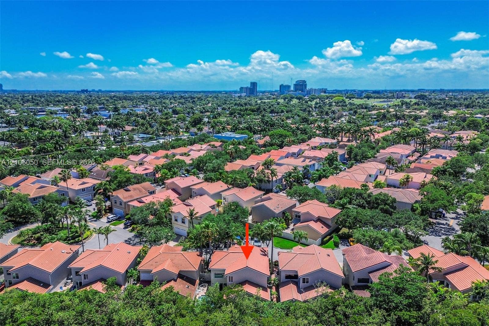1065 Weeping Willow Way, #0, Hollywood, Hollywood, FL 33019 Aerial perspective featuring a residential property with a tiled roof, situated within a landscape of mature trees and urban skyline scenery