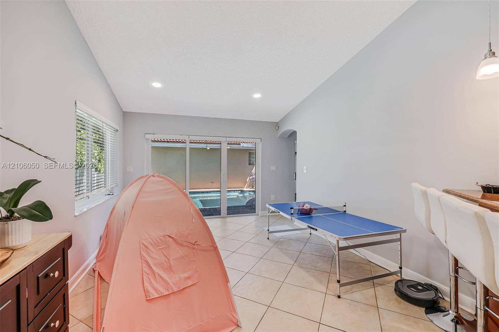 1065 Weeping Willow Way, #0, Hollywood, Hollywood, FL 33019 Vaulted ceilings with recessed lighting, tile flooring, sliding glass doors, and a built-in wet bar with cabinetry