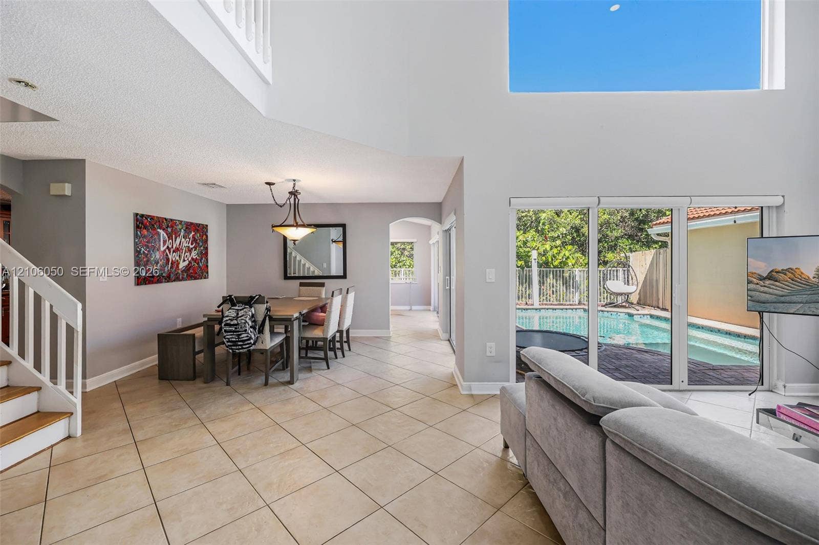 1065 Weeping Willow Way, #0, Hollywood, Hollywood, FL 33019 Vaulted ceilings, porcelain tile flooring, sliding glass doors, and a wood-railing staircase