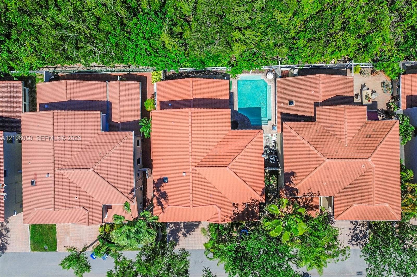 1065 Weeping Willow Way, #0, Hollywood, Hollywood, FL 33019 Aerial perspective of multi-structure property featuring red clay tile roofing, private swimming pool, paved patio, and mature perimeter landscaping