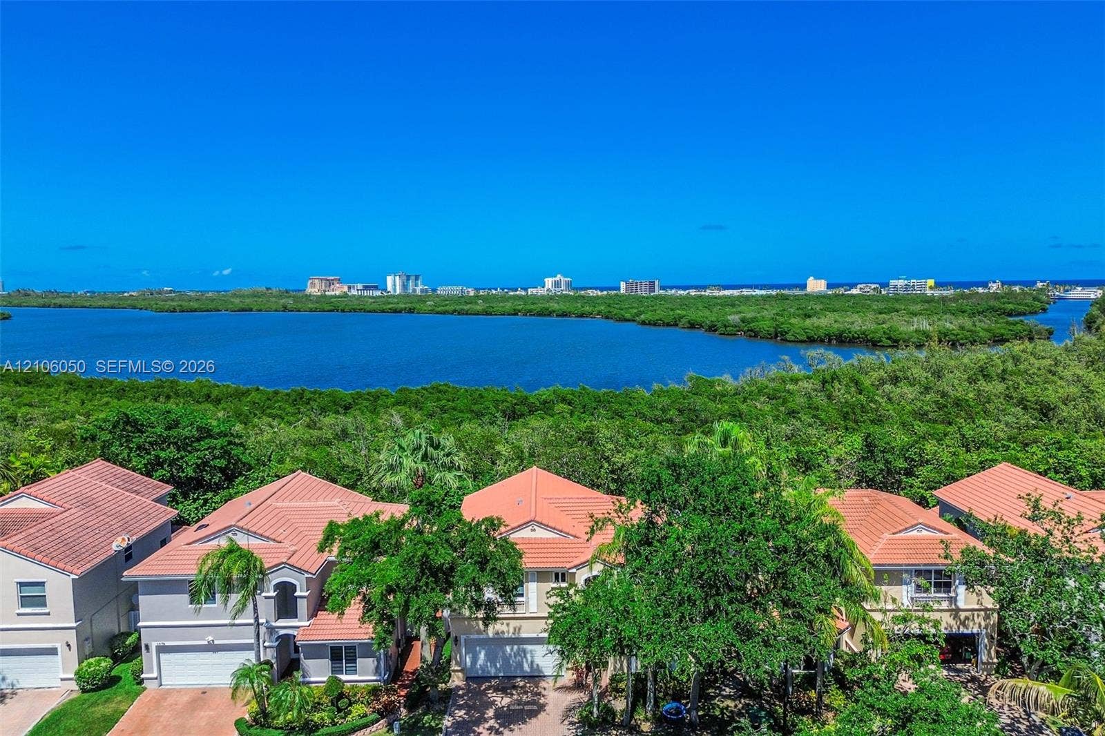 1065 Weeping Willow Way, #0, Hollywood, Hollywood, FL 33019 Aerial perspective featuring tile-roofed residences, extensive natural vegetation, and open water frontage