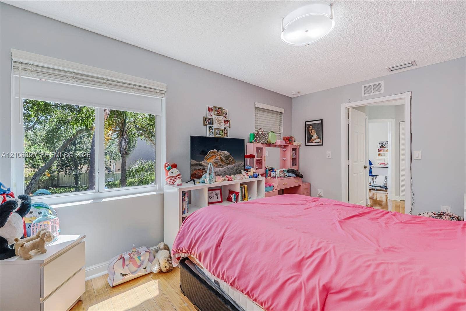 1065 Weeping Willow Way, #0, Hollywood, Hollywood, FL 33019 Bedroom featuring wood-finish flooring, dual-pane windows, and a flush-mount overhead light fixture