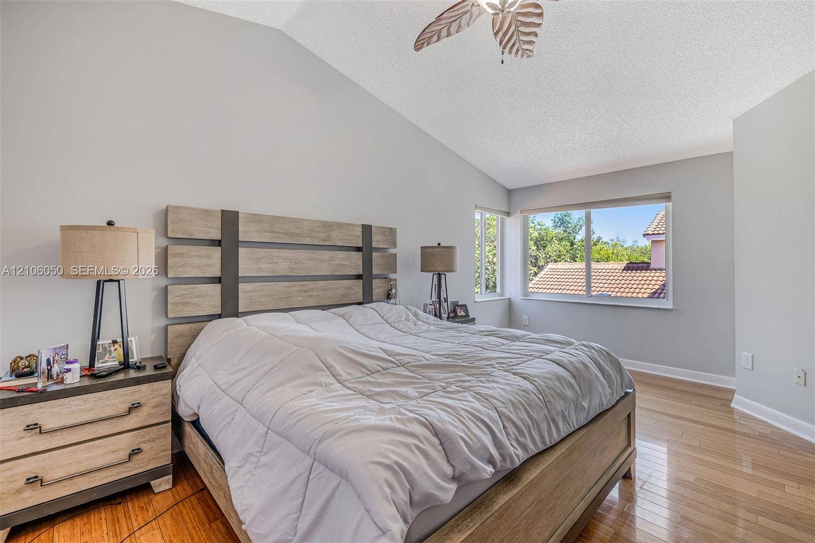 1065 Weeping Willow Way, #0, Hollywood, Hollywood, FL 33019 Vaulted ceiling with a central fan, light-toned wood-finish flooring, and large sliding windows