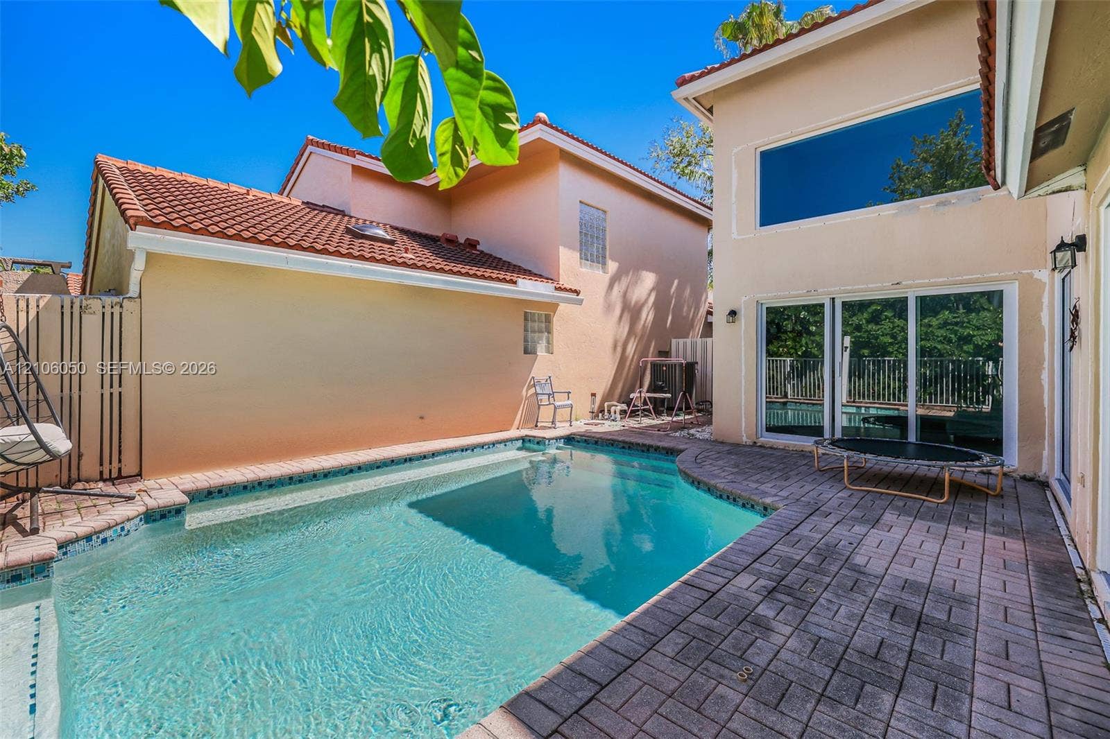 1065 Weeping Willow Way, #0, Hollywood, Hollywood, FL 33019 Stucco exterior with a tiled roof featuring an in-ground swimming pool and expansive paver patio