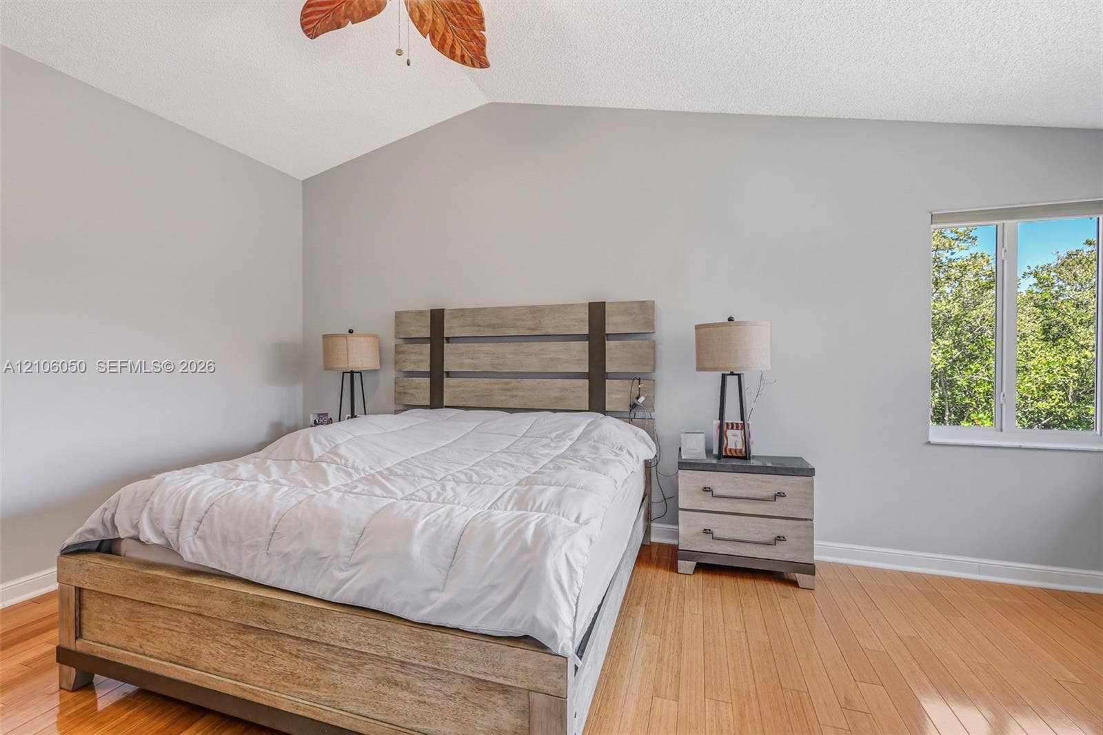 1065 Weeping Willow Way, #0, Hollywood, Hollywood, FL 33019 Vaulted ceilings, wood-finish flooring, and natural light from a single-pane window