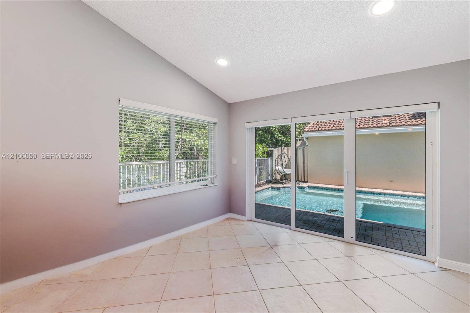 1065 Weeping Willow Way, #0, Hollywood, Hollywood, FL 33019 Interior space featuring vaulted ceilings, recessed lighting, tile flooring, and oversized sliding glass doors