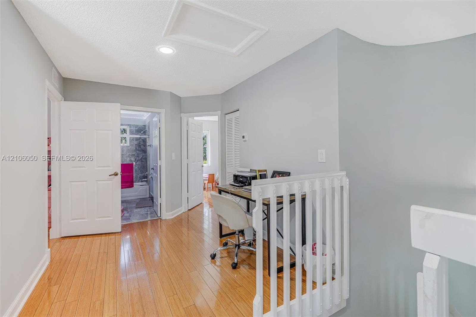 1065 Weeping Willow Way, #0, Hollywood, Hollywood, FL 33019 Interior hallway featuring wood-finish flooring, white paneled doors, recessed lighting, and a white vertical balustrade