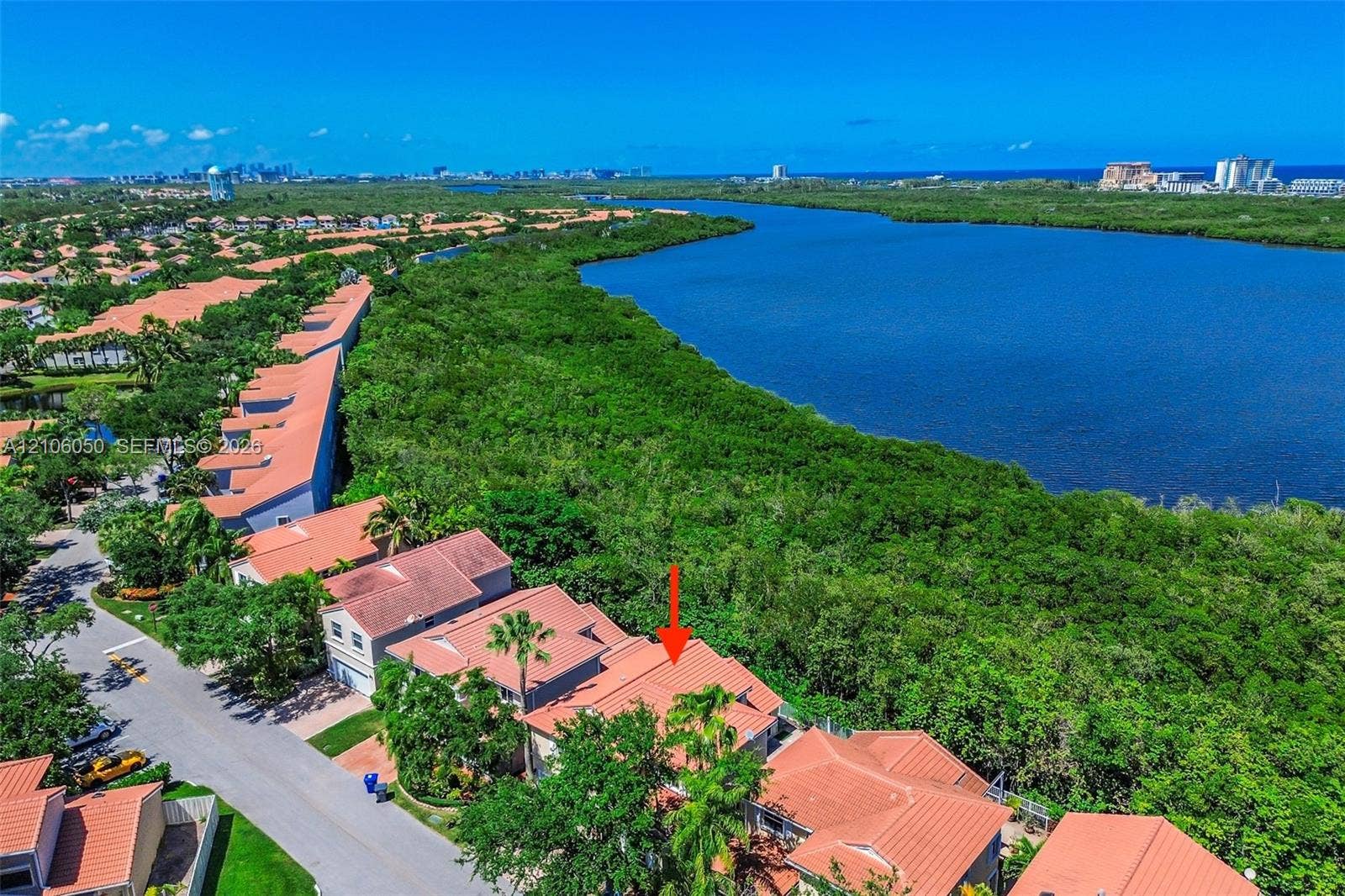 1065 Weeping Willow Way, #0, Hollywood, Hollywood, FL 33019 Aerial perspective featuring terracotta-style roofing, two-story structural design, and proximity to coastal water and native vegetation