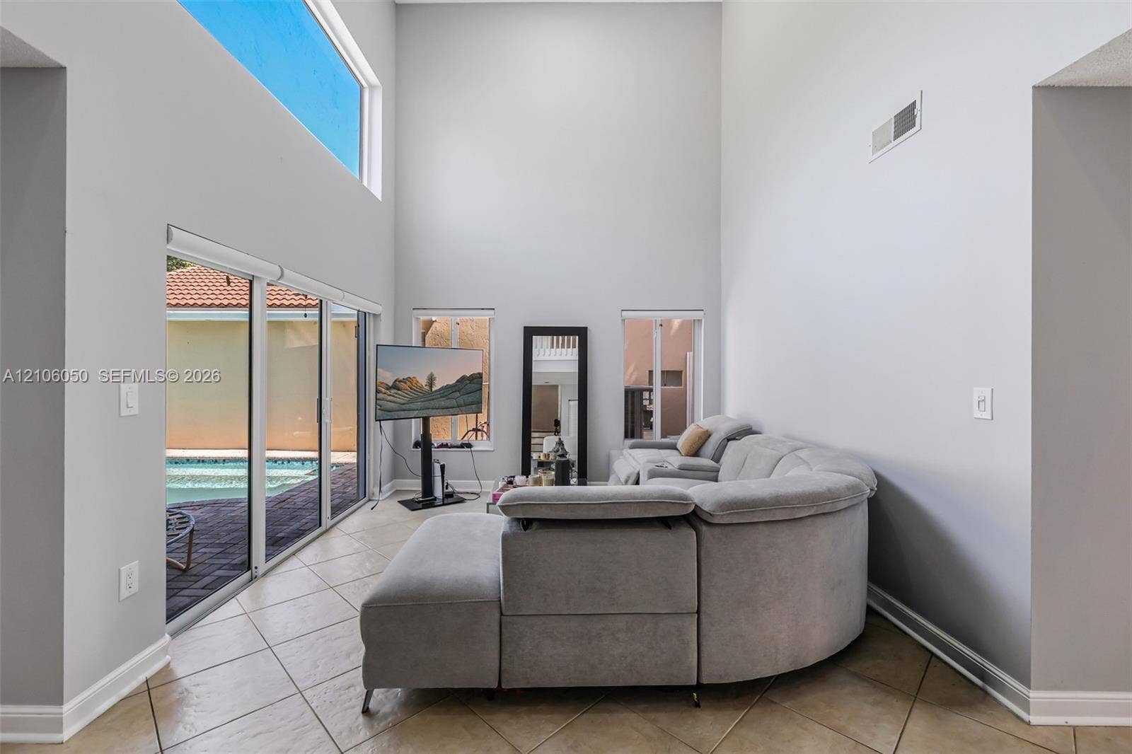 1065 Weeping Willow Way, #0, Hollywood, Hollywood, FL 33019 Double-height ceilings, ceramic tile flooring, expansive sliding glass doors, transom window, and dual vertical windows