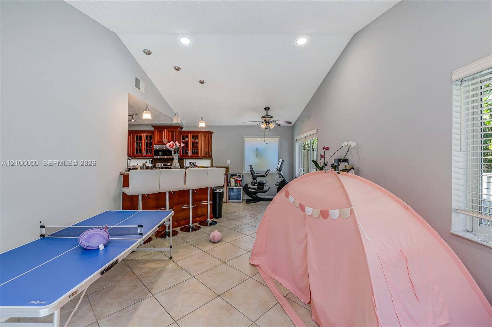 1065 Weeping Willow Way, #0, Hollywood, Hollywood, FL 33019 Vaulted ceilings, tile flooring, recessed lighting, and kitchen cabinetry featuring a raised breakfast bar with three pendant lights