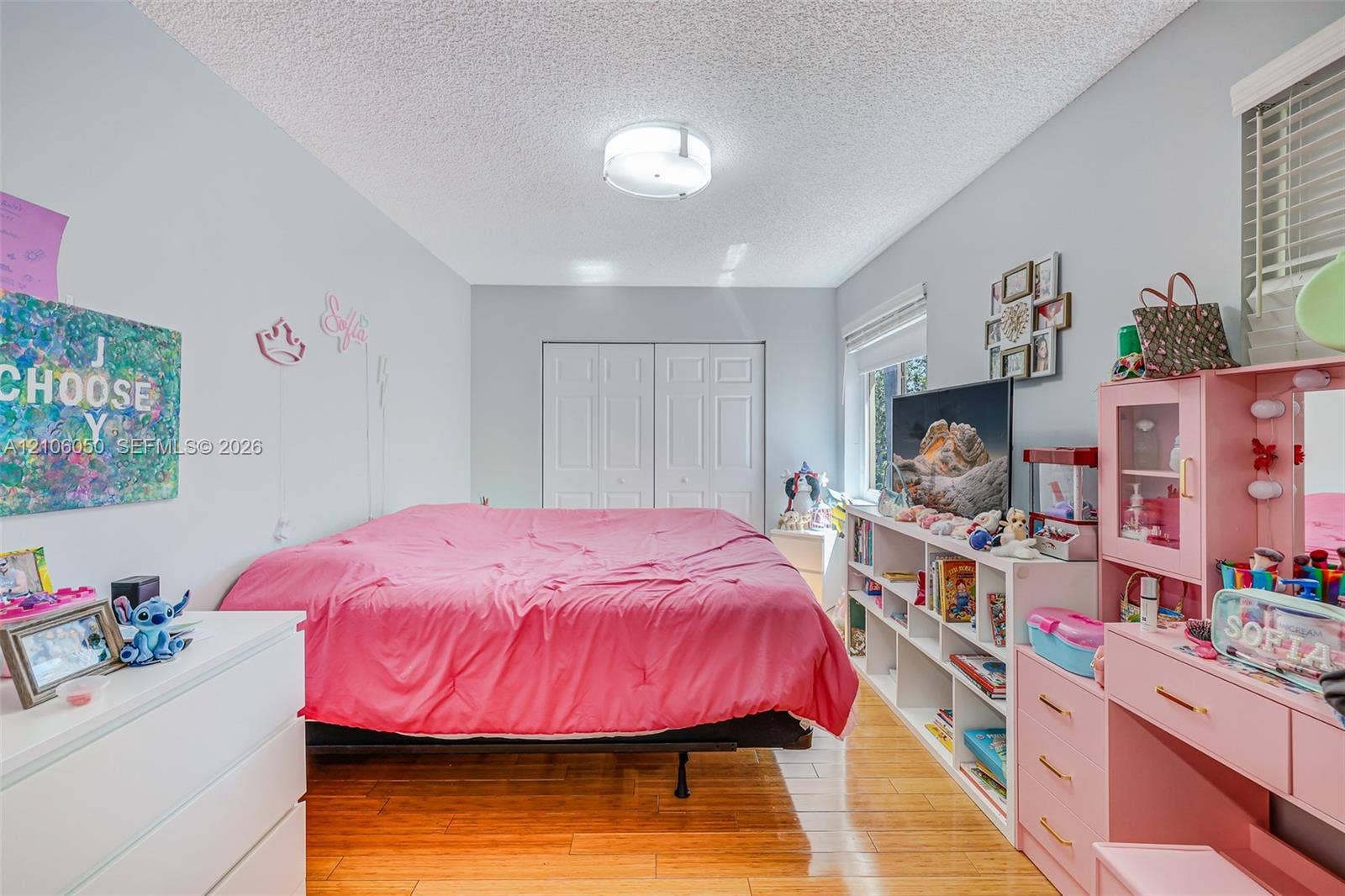 1065 Weeping Willow Way, #0, Hollywood, Hollywood, FL 33019 Wood-finish flooring, white double-door reach-in closet, flush-mount ceiling light fixture, and windows with horizontal blinds