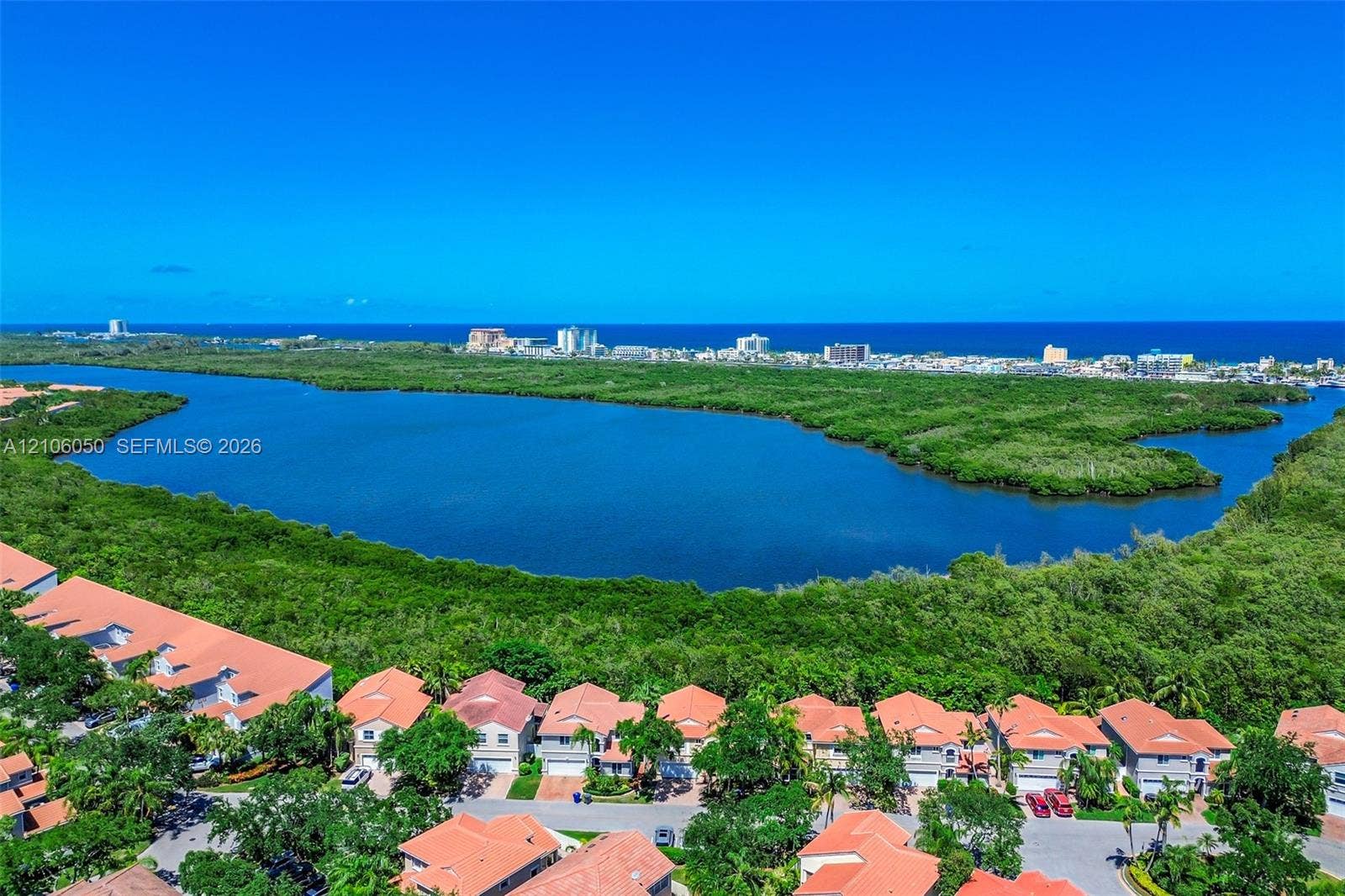 1065 Weeping Willow Way, #0, Hollywood, Hollywood, FL 33019 Aerial perspective featuring residential structures with clay-tile roofs, expansive mangrove preserve, and coastal horizon