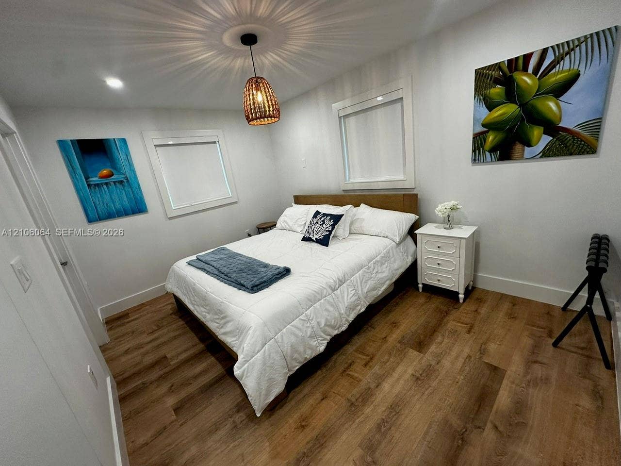 179 Azalea Street, Islamorada, FL 33070 Wood-finish flooring, recessed lighting, and a textured woven pendant light fixture