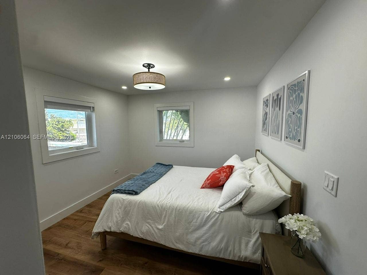 179 Azalea Street, Islamorada, FL 33070 Wood-finish flooring, recessed ceiling lighting, a drum shade flush-mount fixture, and double-pane windows