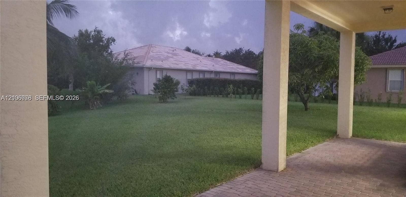 13382 Lakepointe Circle, #0, Cooper City, Cooper City, FL 33330 Covered patio with brick-paver flooring, concrete support columns, and expansive lawn