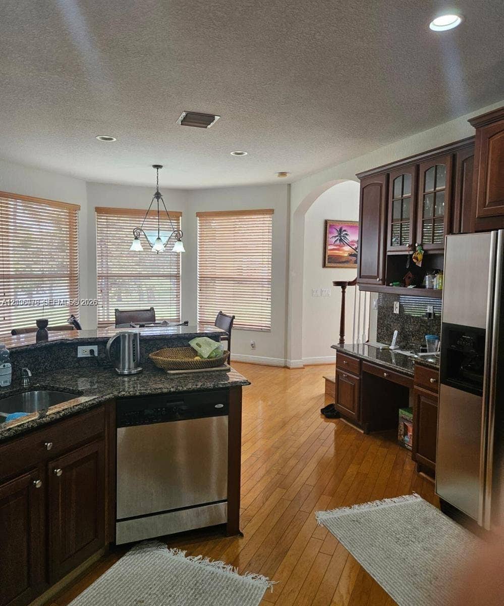 13382 Lakepointe Circle, #0, Cooper City, Cooper City, FL 33330 Kitchen featuring wood-finish cabinetry, stone countertops, stainless steel appliances, wood-finish flooring, and recessed lighting