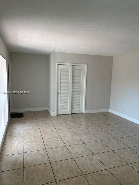 324 SE 10th Avenue, #1-8, Pompano Beach, Pompano Beach, FL 33060 Kitchen featuring white cabinetry, contrasting dark countertops, a double-basin sink, stainless steel appliances, and ceramic tile flooring
