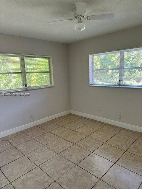 324 SE 10th Avenue, #1-8, Pompano Beach, Pompano Beach, FL 33060 Ceramic tile flooring, white louvered sliding closet doors, and ceiling-mounted light fixture with fan