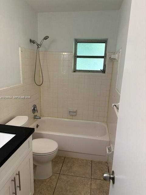 324 SE 10th Avenue, #1-8, Pompano Beach, Pompano Beach, FL 33060 Bathroom featuring a vanity with a dark countertop and integrated rectangular sink, illuminated rectangular mirror, white cabinetry with brushed metal hardware, and a tiled shower-tub combination
