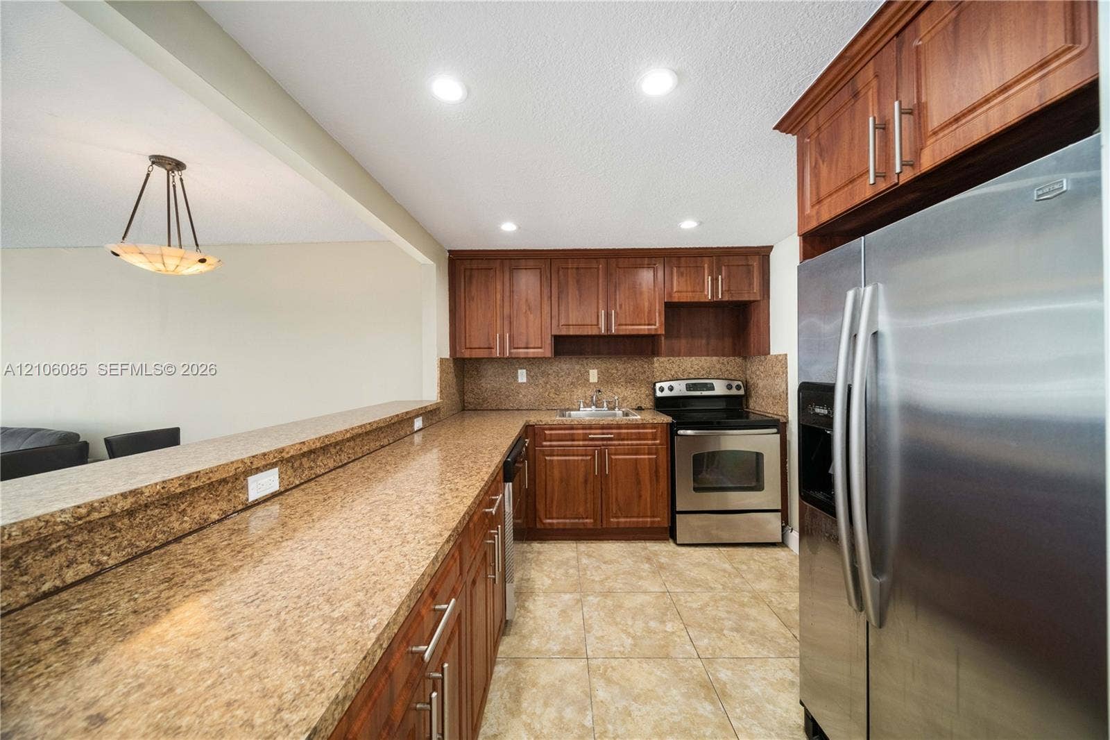 16710 NE 9th Avenue, #705, North Miami Beach, North Miami Beach, FL 33162 Kitchen featuring wood cabinetry, stone-finish countertops, stainless steel appliances, tile flooring, and recessed lighting