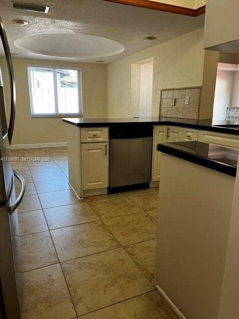 1325 N 74th Terrace, #0, Hollywood, Hollywood, FL 33024 Kitchen featuring white cabinetry, dark countertops, a stainless steel dishwasher, large-format tile flooring, and a circular recessed ceiling fixture
