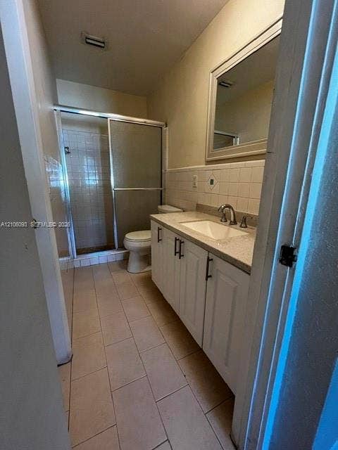 1325 N 74th Terrace, #0, Hollywood, Hollywood, FL 33024 White vanity cabinet with stone-composite countertop, rectangular undermount sink, ceramic tile flooring, and walk-in shower with sliding glass doors