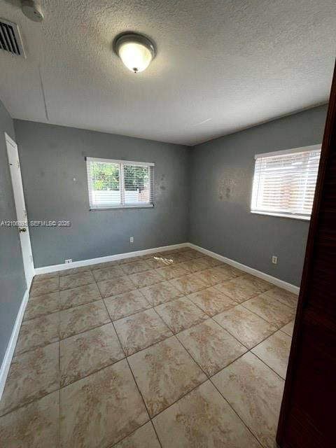 1325 N 74th Terrace, #0, Hollywood, Hollywood, FL 33024 Interior space featuring tile flooring, neutral wall paint, two windows with horizontal blinds, and a dome-style flush mount ceiling light
