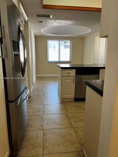 1325 N 74th Terrace, #0, Hollywood, Hollywood, FL 33024 Kitchen featuring a stainless steel refrigerator, tile flooring, built-in cabinetry, dark countertops, and a circular recessed ceiling detail
