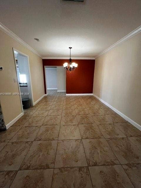 1325 N 74th Terrace, #0, Hollywood, Hollywood, FL 33024 Large-format tile flooring, crown molding, and a multi-arm chandelier featuring clear glass shades