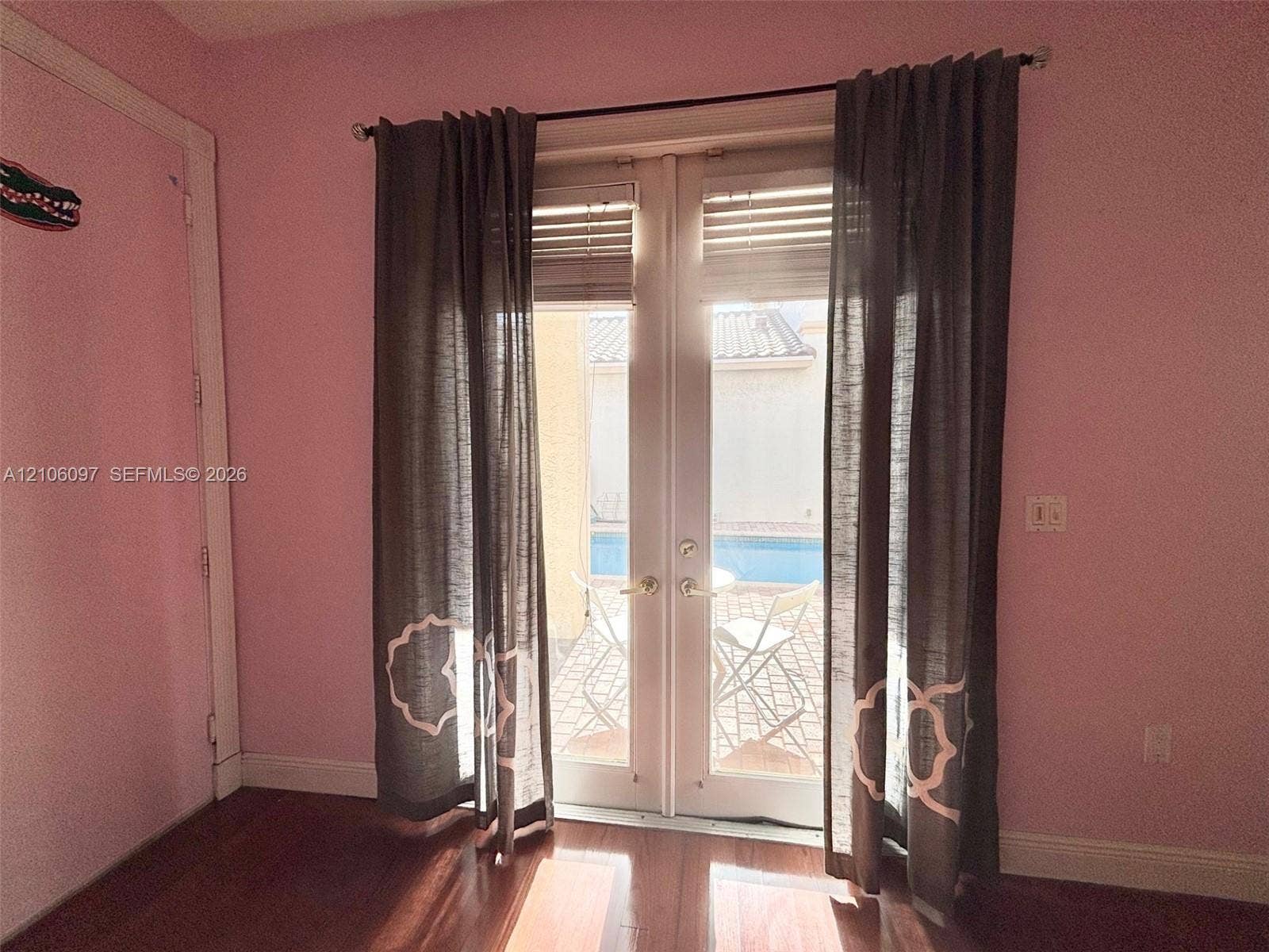 1141 Waterside Lane, Hollywood, FL 33019 Bedroom has french doors overlooking the pool