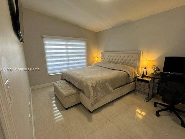 16284 SW 100th Terrace, Miami, FL 33196 Room featuring large-format tile flooring, vaulted ceilings, and horizontal sheer window treatments