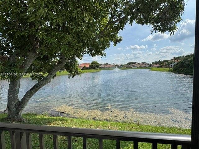 16284 SW 100th Terrace, Miami, FL 33196 Waterfront property featuring a lake, water fountain, and mature tree
