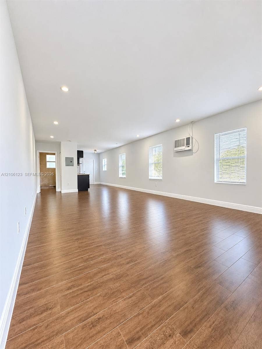 123 NW 15th Street, #U, Miami, Miami, FL 33136 Open-concept interior featuring wood-finish flooring, recessed lighting, and multiple windows