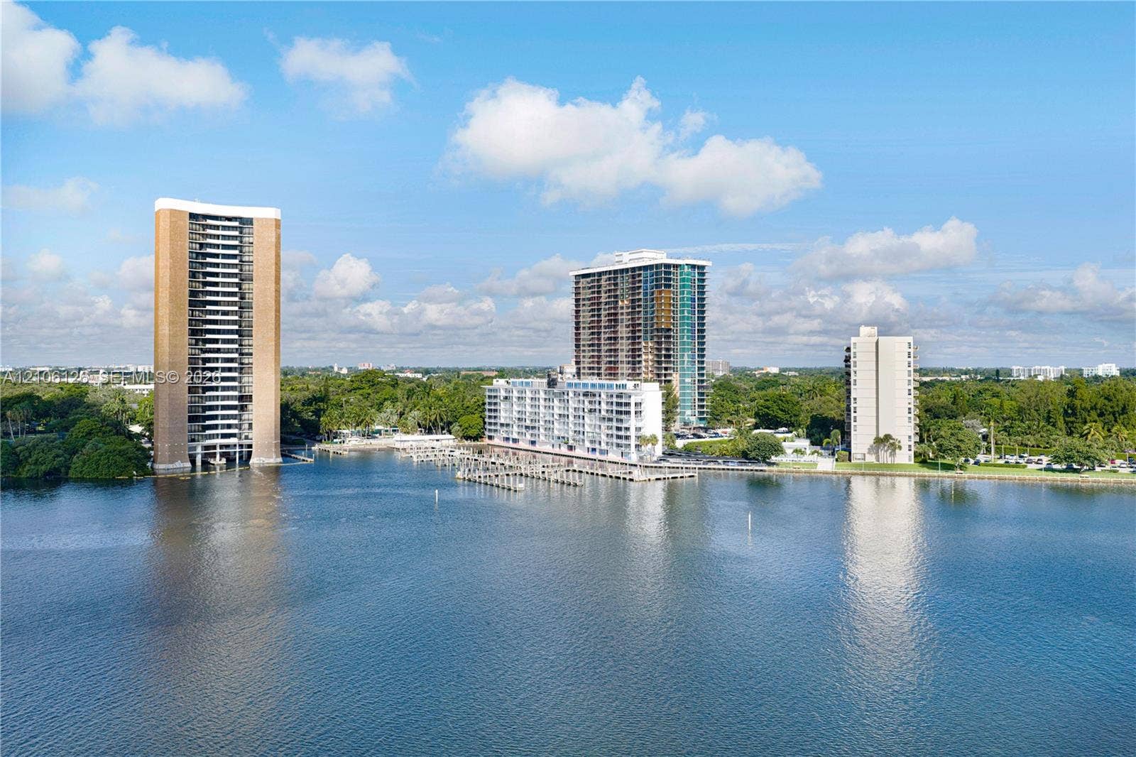 Waterfront high-rise complex featuring deep-water boat slips, private dockage, and extensive shoreline perimeter