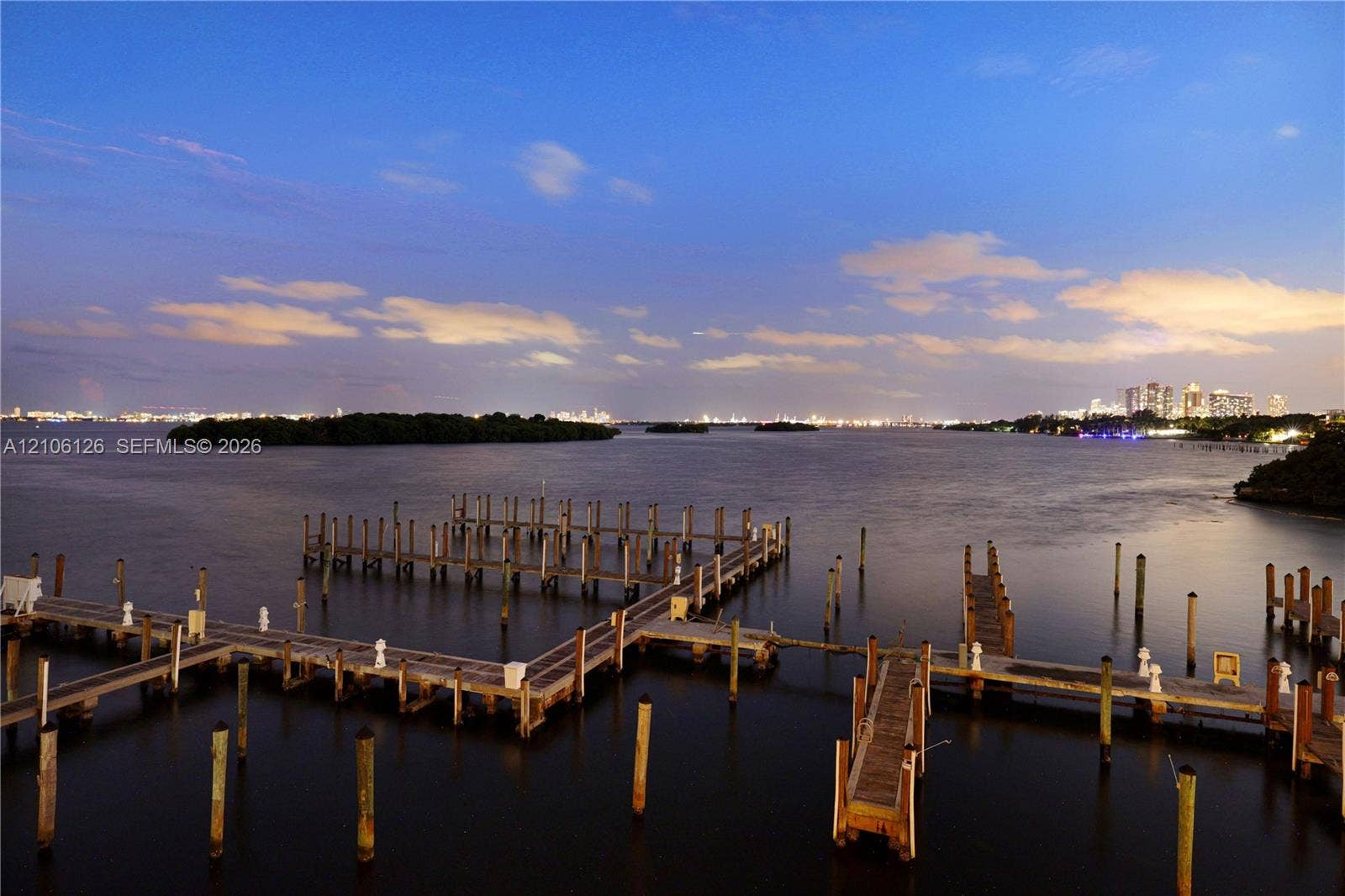 Deep-water dockage featuring multiple wooden slip structures with concrete pilings and fixed marine lighting