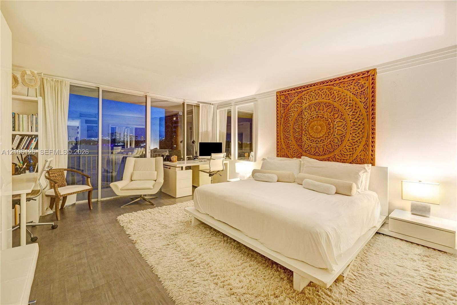 Floor-to-ceiling sliding glass panels, wood-finish flooring, and built-in shelving
