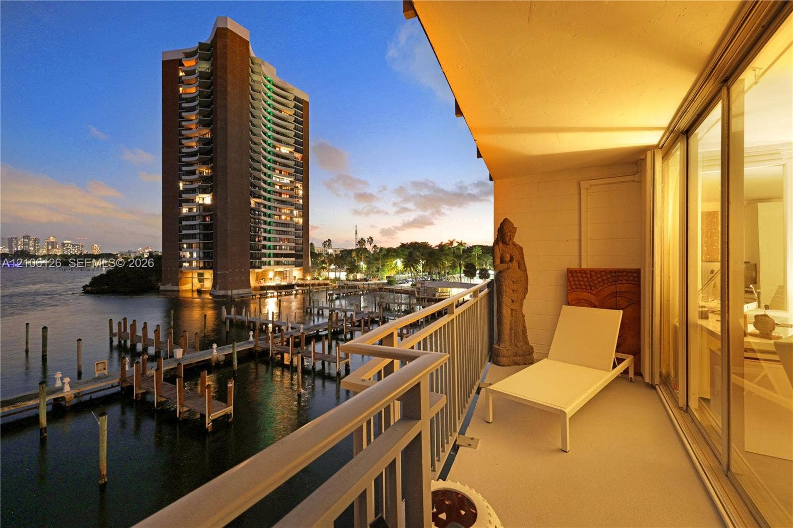 Private balcony featuring metal railings and floor-to-ceiling glass sliding doors