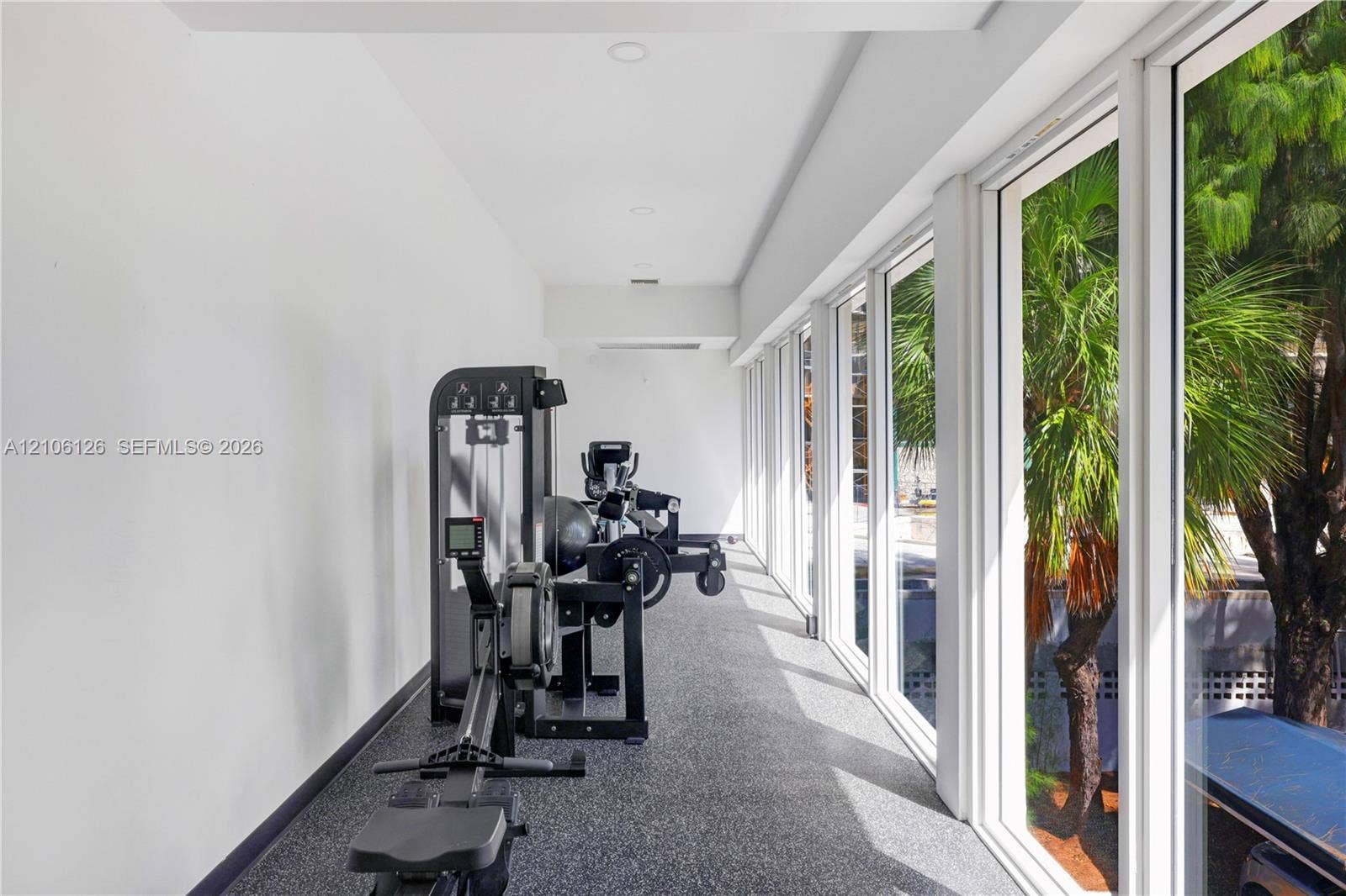 Expansive floor-to-ceiling windows, recessed lighting, and durable flooring