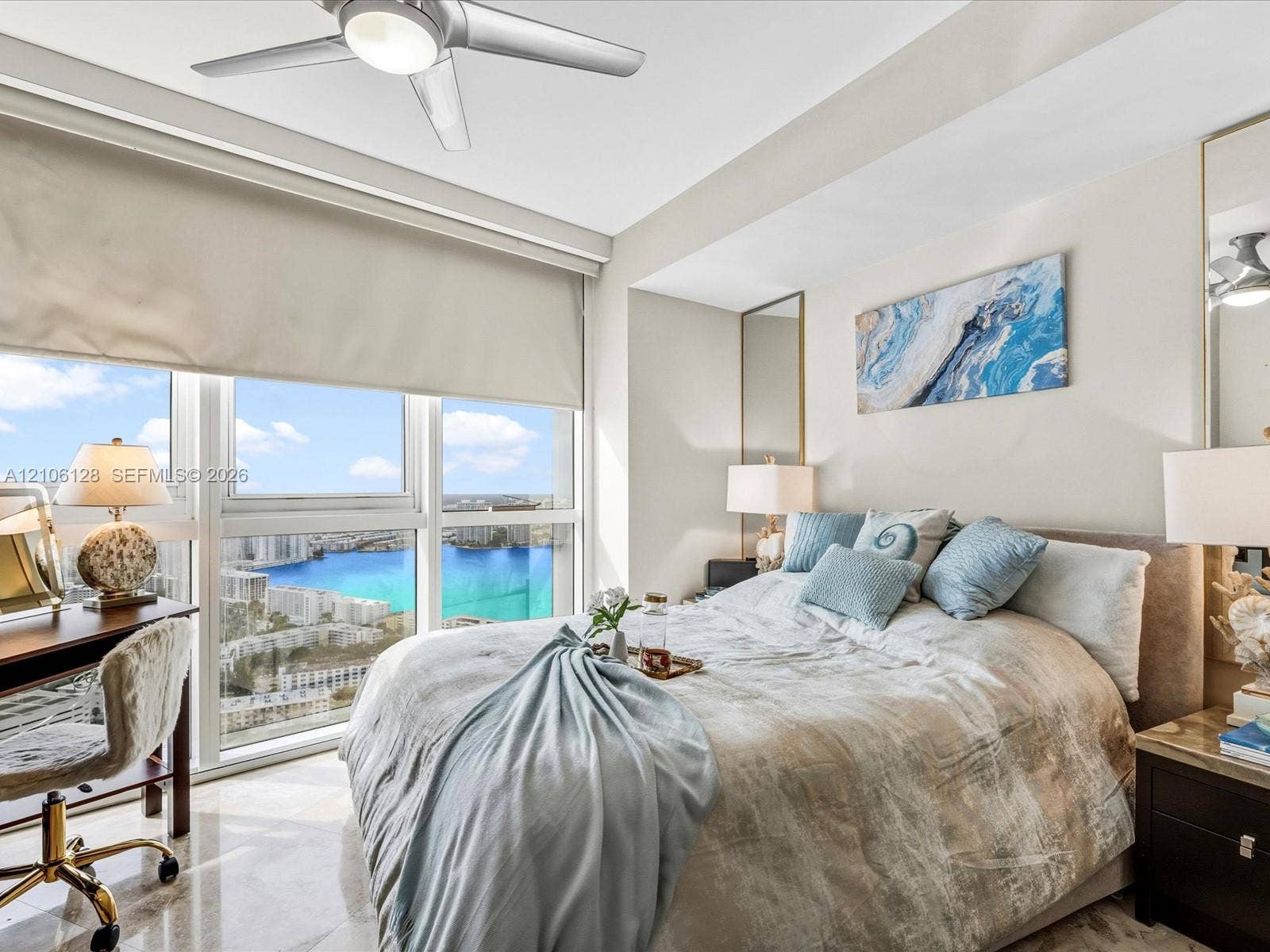 Floor-to-ceiling windows, polished stone flooring, recessed ceiling fan with integrated lighting, and full-length vertical wall mirrors