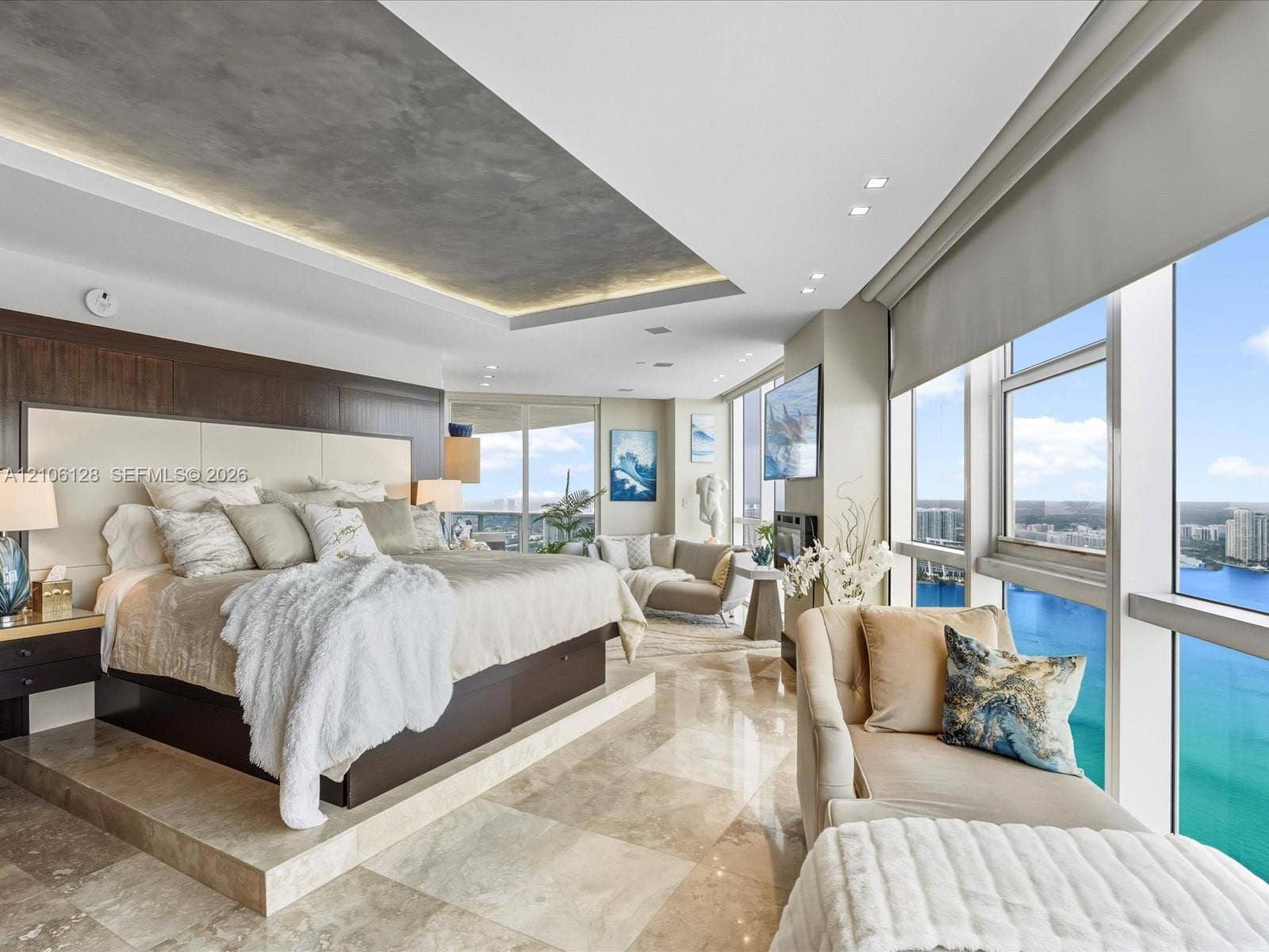 Floor-to-ceiling windows, polished stone flooring, recessed ceiling feature with ambient lighting, and dark wood-finish wall paneling
